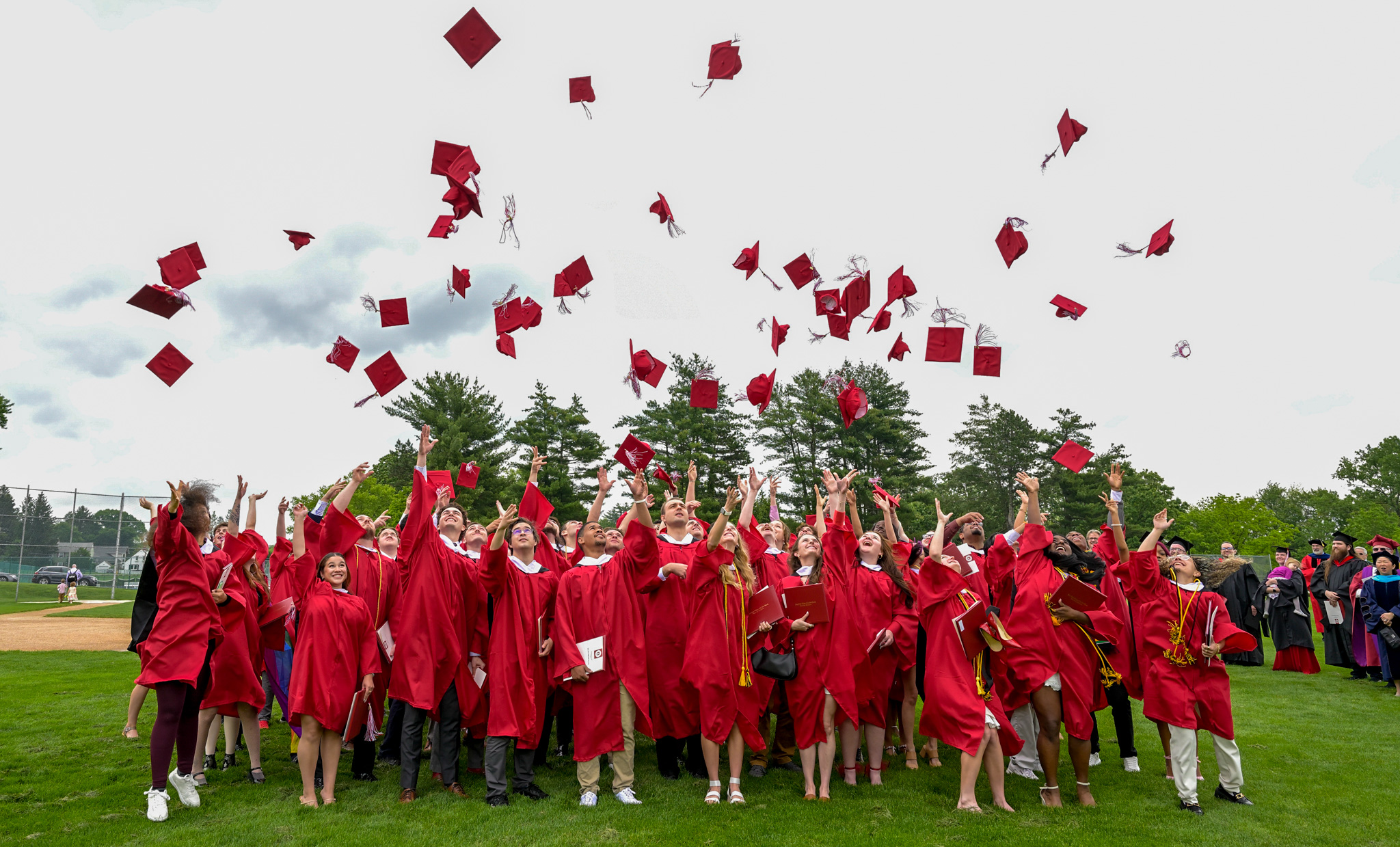 Class of 2022 graduates toss their graduation hats in celebration