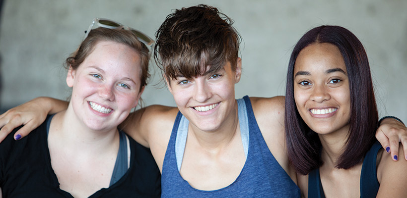 Bryn Athyn College group of three female students smiling during freshman orientation