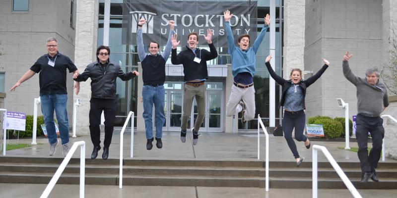 Bryn Athyn College students and professors jump into the air at the mid-Atlantic chapter of the Ecological Society of America annual conference