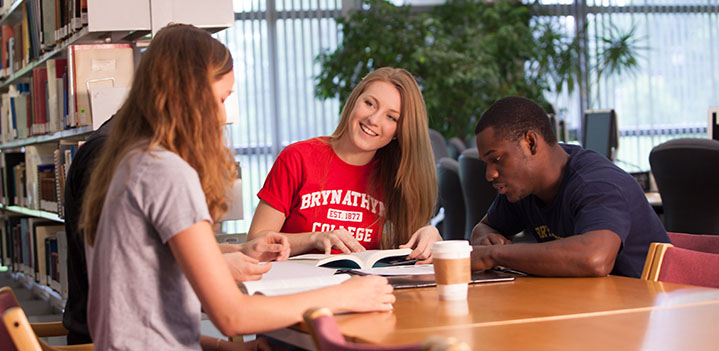 Students working at a table in the library