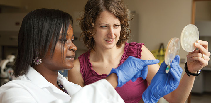 Student and professor look at a sample in the lab