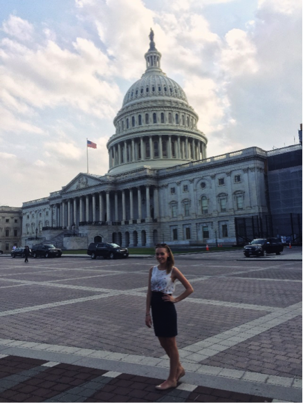 Student posing in front of capitol building