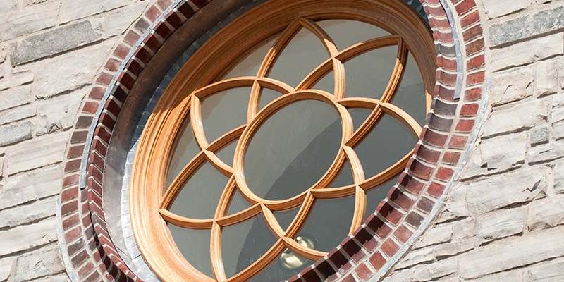 Bryn Athyn College Brickman Center rose window with wood detailing in the shape of a flower