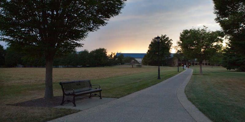 Bryn Athyn Collge view of the campus meadow and the sun setting behind the library