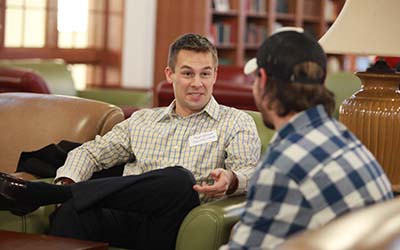 Bryn Athyn College alumni talks to a student