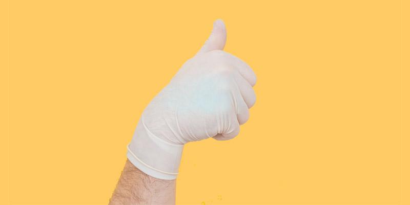 gloved hand gives a thumbs up