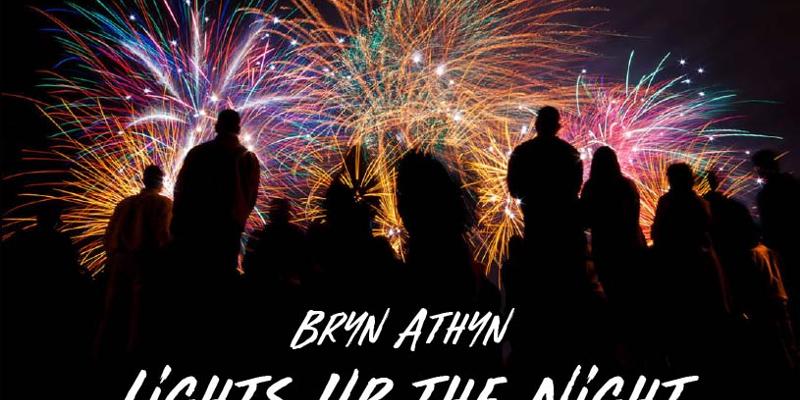 silhouette of spectators looking at brilliant bursts of fireworks in the night sky, with the caption Bryn Athyn Lights Up the Night.