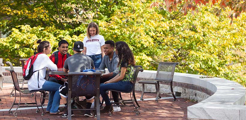 Bryn Athyn College students hang out on the Brickman Terrace during a fall afternoon