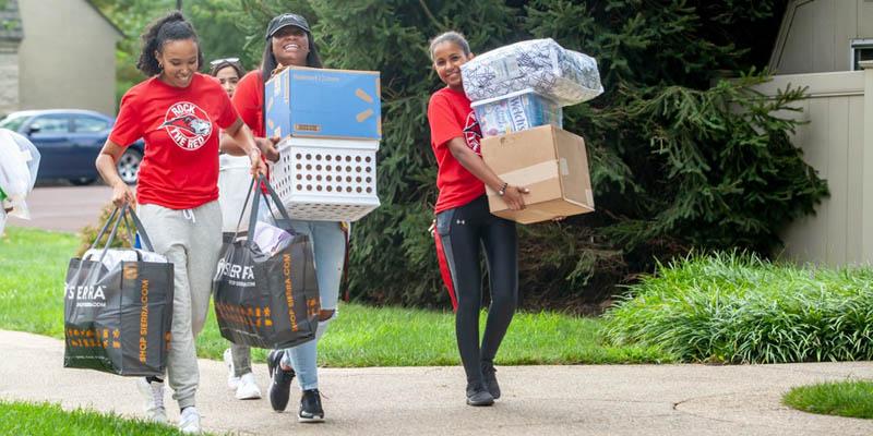 Bryn Athyn College Residence Hall assistants help a fellow student move in during orientation