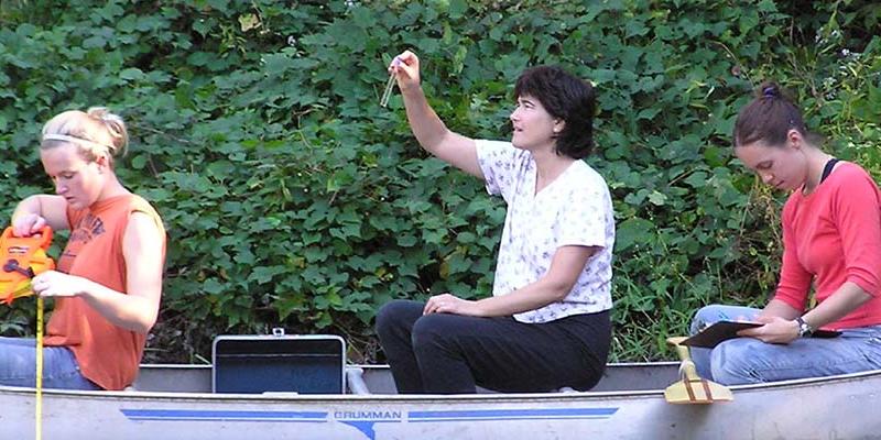 Bryn Athyn College Professor Sherri Cooper with students in a canoe doing field work