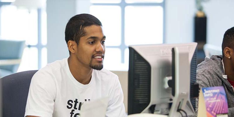 Bryn Athyn College students using the computers in the library computer lab